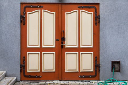 The red armored steel gates  door is disguised under the wooden. Mass productionの写真素材