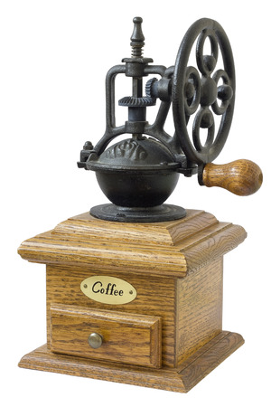 The mechanical coffee grinder is made a retro of cast iron and a oak  tree. Mass production. Isolatedの写真素材