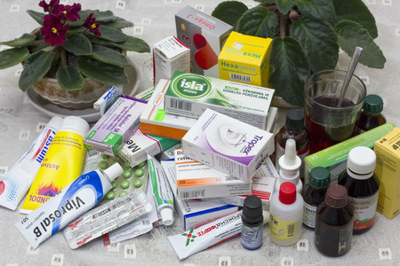 VILNIUS, LITHUANIA - MARCH 26, 2016:  Life of the elderly person depends on drugs. Various tablets, pills, ointments and tinctures lie on a little table at a bed.のeditorial素材