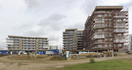 VILNIUS, LITHUANIA - APRIL 17, 2016: Big construction of new  multi-storey inhabited modern buildings in a  wild forest city area Pilaite. Rainy spring dayのeditorial素材
