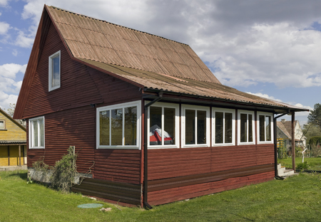 VILNIUS, LITHUANIA - MAY 07, 2016: The typical hand made wooden house is built in the eighties the twentieth century.Public garden association Kalorija near the village of Rastenenai. Sunny May dayのeditorial素材