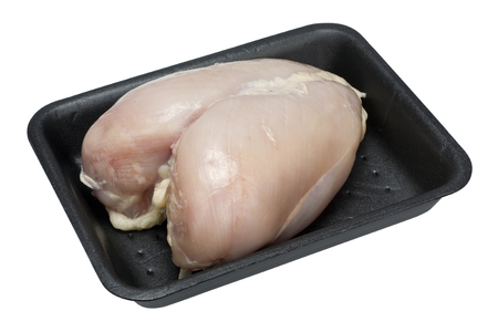 Fresh raw chicken breast with bones in the standard plastic black container. Isolated with patchの写真素材