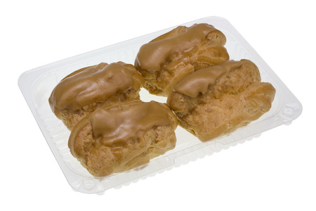 Four  Eclair cakes with scalded carmel and coffee butter cream in standard plastic packing box....