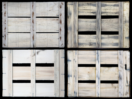 Back side closeup view of aged used dirty wooden fruits boxes set. Isolated on blackの写真素材
