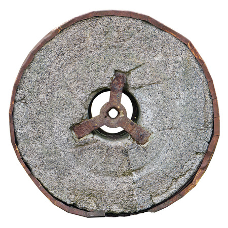 Stone granite wheel with rusted metal rim isolated on whiteの写真素材