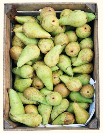 Street sale of fresh green pears in wooden boxe.Isolated on white