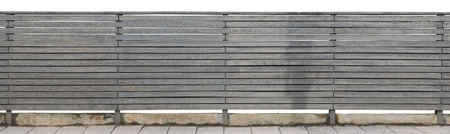 The rural long solid fence is made of horizontal wooden boards and painted with gray oil paint. Isolated panoramic collage from several outdoor photosの写真素材