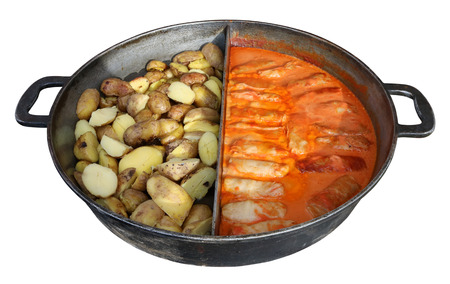 Street fast food - stuffed cabbage with mincemeat and boiled potato in big fried pan. Isolated on...