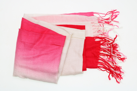 The red light women's scarf  with fringe of thread lies on a white tableの写真素材