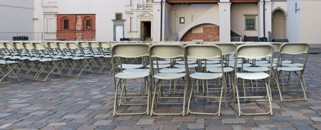 Hundreds of folding chairs are installed on the granite public  square of the old European city. Soon there will begin a concert of classical musicのeditorial素材