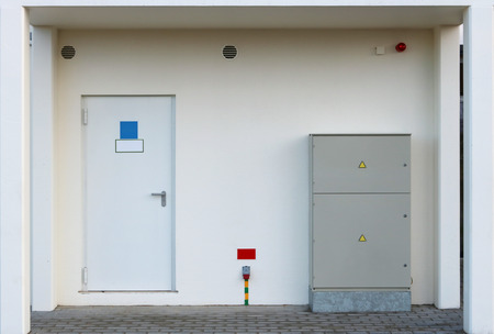 Portal in a new house with a door into the room with water counters  and an electrical junction box....
