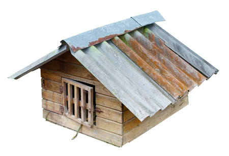 The winter dog house has a roof made of wavy slate and a latticed door. Isolated on white  rural outdoor shotの写真素材