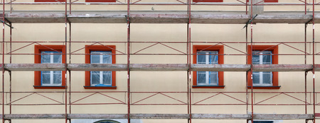 Metal scaffolding and fittings used in the restoration of the old building. Panoramic collage from several oudoor photosの写真素材