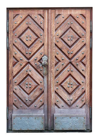Wooden oak door with a bronze handle in the basement of a Catholic medieval temple. Isolated on white outdoor shotの写真素材