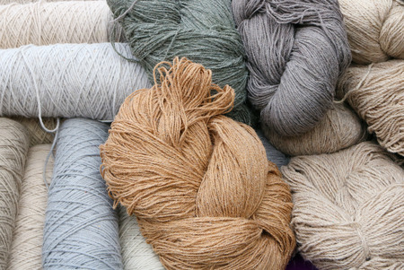 Hanks of thread from coarse sheep wool for knitting warm sweaters backgound