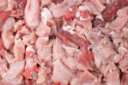 Fresh pork  fillet is cut into small pieces for making minced meat on a grinder. Studio macro food backcground shotの写真素材