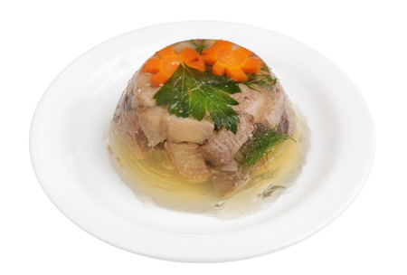 Homemade rural,  meat jelly from beef tongue with vegetables on a  plate. Isolated on white studio macro shotの写真素材