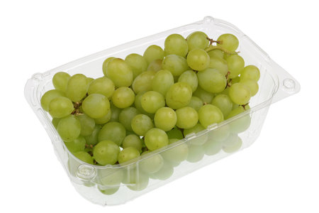 Green  sweet grapes berries  in a clear plastic container.Isolated with patch  studio macro shotの写真素材