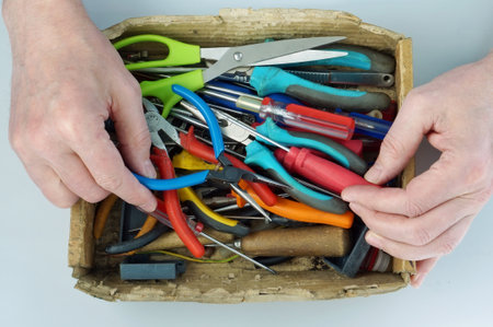Old sick home master chooses the right tool from cardboard box  for home appliances repairの写真素材