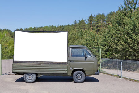 An old no name green army truck with a empty  billboard set in a pine  forest . Contains isolated with patch  areaの写真素材