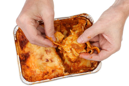Old poor man eat with hands  fat  meat pork  lasagna . Isolated on white studio closeupの写真素材