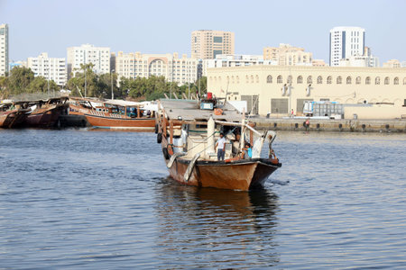 Dubai, United Arab Emirates - December 03, 2019. The reverse side of the capital seaport. A small steel rusty private no name merchant ship against the background of urban skyscrapers landscapeの写真素材