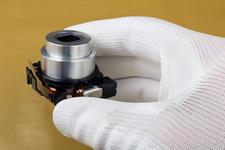 IT engineer technician controls the  modern lens assy  for avideo  camera. Masss production.  Modern...