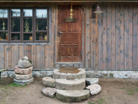Big granite stones near the  old door  of ruaral barn for storage of firewood and agricultural tools. Panoramic collage from several outdoor shotsの写真素材