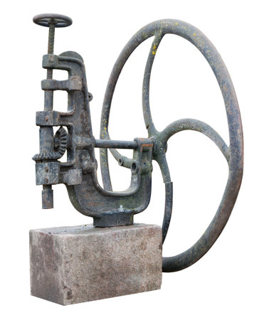 Old rusty mechanism with a wheel and gears. Used as an oil press. Isolated on whiteの写真素材