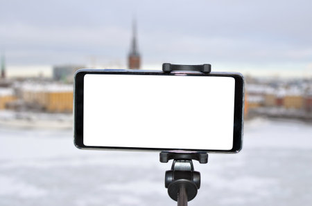 The city landscape is filmed with a phone on a selfie stickの写真素材