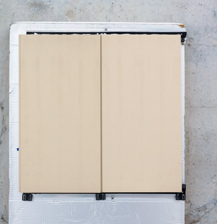 Samples of outdoor stone slabs installed on a gray fresh concrete building  wallの写真素材