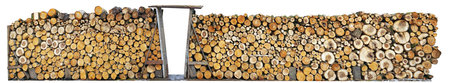 Rustic fence made from logs of firewood