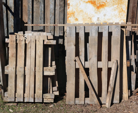 Old used wooden pallets near a rustic  barnの写真素材