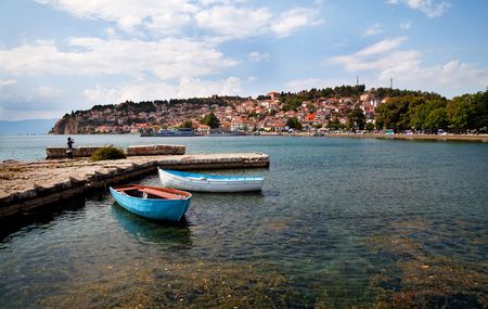 two boats by a quay, old town of Ohrid at the backgroudの写真素材