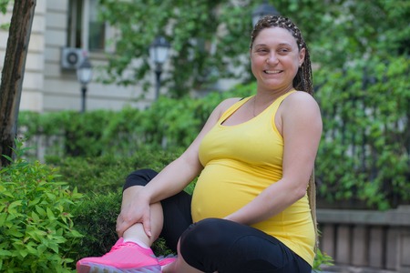 Smiling Pregnant Woman Outdoorsの写真素材