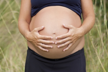 Hands on a pregnant belly の写真素材