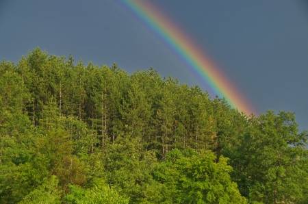 Beautiful rainbow over cloudy sky  A symbol of hope and peaceの写真素材