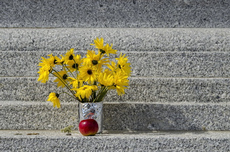 Bouquet of yellow flower Sunflower plant or Heliopsis helianthoides and apple on the stupa Sofia, Bulgariaの写真素材