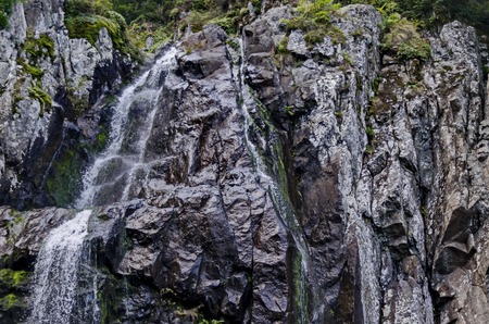 Upper part of fresh Boyana waterfalls in deep forest and rock, Vitosha, Bulgaria