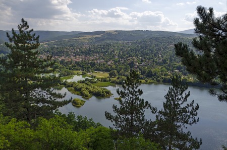 Scene with mountain, lake, glade, forest and residential district of bulgarian village Pancharevo, Sofia, Bulgariaの写真素材