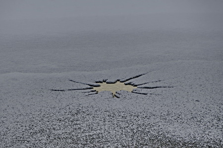 Interesting natural background of thawing at frozen lake in village Pancharevo, Sofia, Bulgariaの写真素材