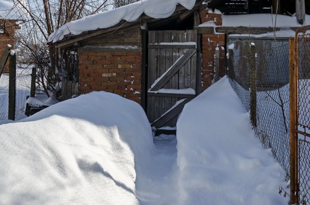 Fragment of building outdoor after heavy snowfall in winter, Zavet, Bulgariaの写真素材