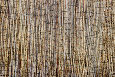 Mat of brown bamboo wire together to create a fence, Plana mountain, Bulgaria