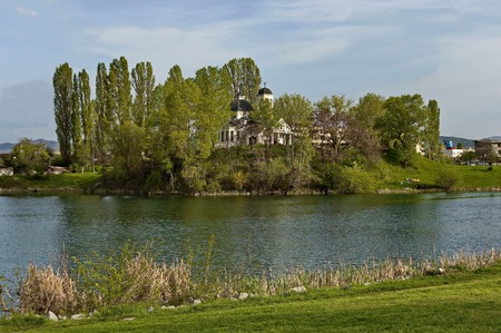 Early springtime green,  lake, bell tower and church with modern architecture in district Drujba, Sofia, Bulgariaの写真素材