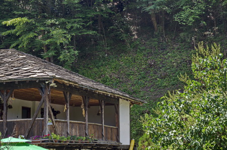 Fragment of old traditional house with balcony in forest, near Pasarel village, Bulgaria