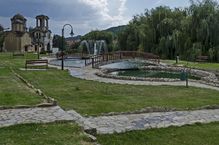 General view of public garden  in  residential district with new orthodox church, two artificial ponds, fountain and two bridges, town Delchevo, Macedonia, Europeの写真素材
