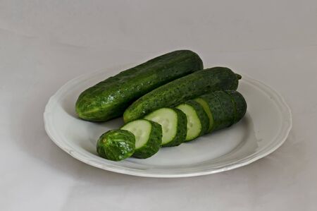 Two whole cucumbers and one with slices on a plate, Sofia, Bulgariaの写真素材