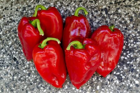 A few red, ripe, raw peppers, paprika or Capsicum with green stem prepared for canning, Sofia, Bulgariaの写真素材