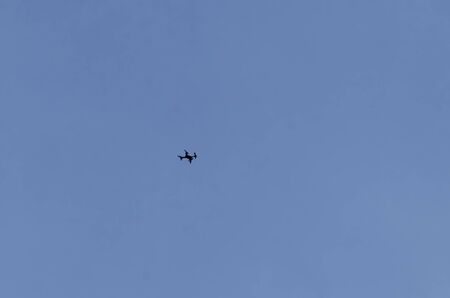 A remote control drone flies high in the sky above Plana mountain, Bulgaria