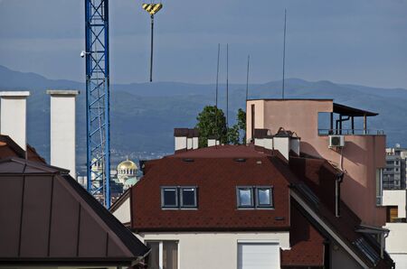 Residential neighborhood with new modern houses against the backdrop of a cityscape in the Bulgarian capital Sofia, Bulgariaの写真素材